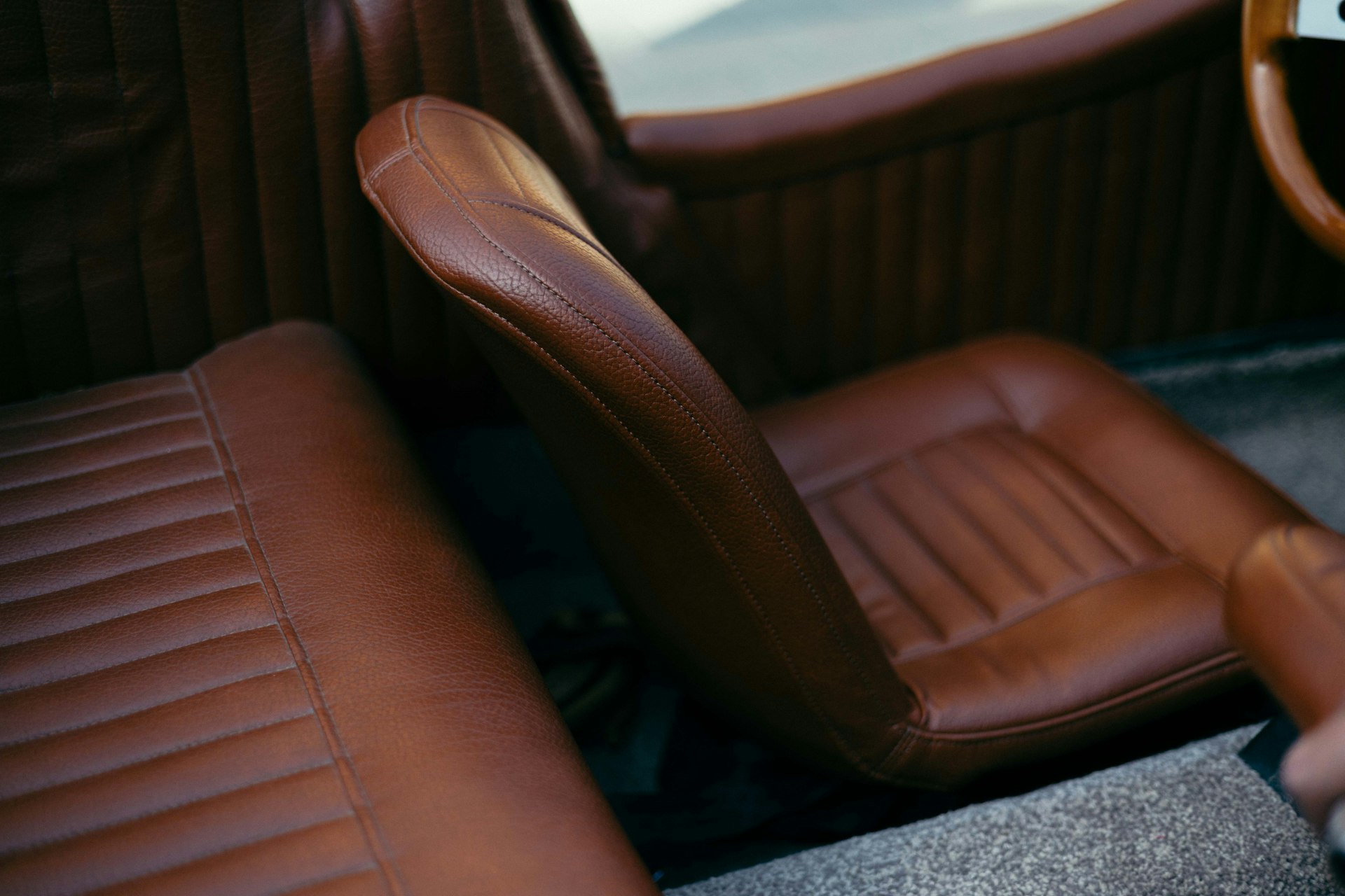 a close up of a car seat with a steering wheel